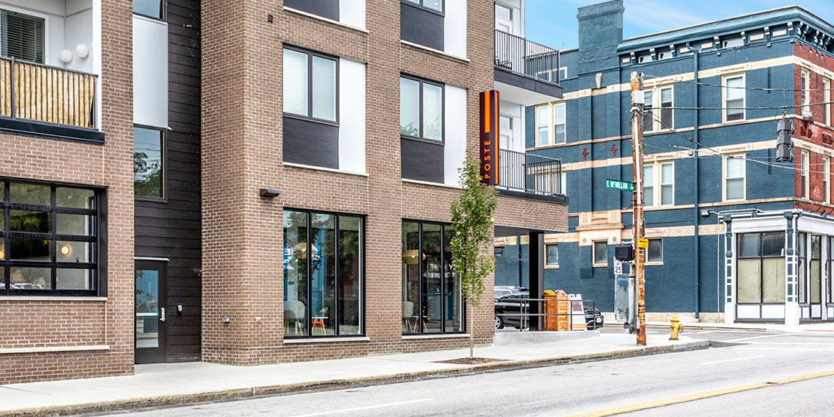 Illuminated Orange Blade Sign at Poste Apartments